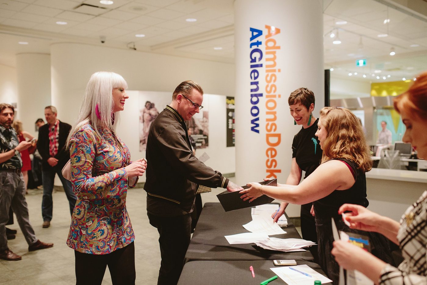 Staff assist guests in Glenbow lobby