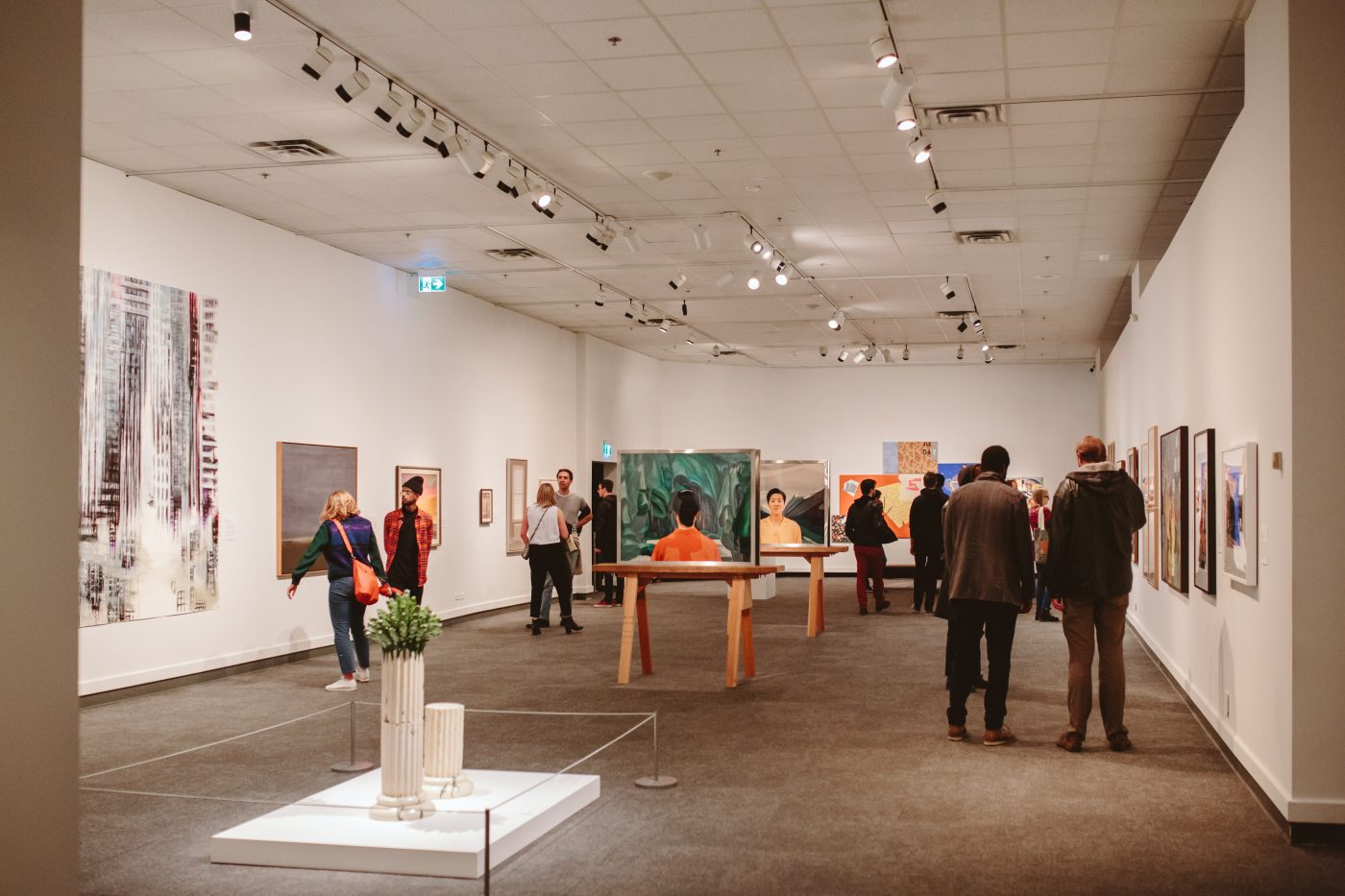 Visitors walk around Glenbow's second floor exhibitions
