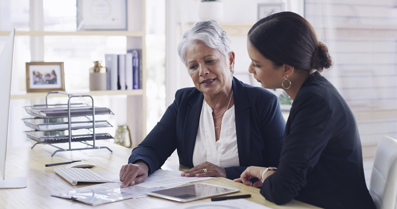 Senior woman, lawyer and document in office for planning, debt settlement and legal guidance. Elderly person, attorney and reading paperwork for retirement fund, asset protection and will information.