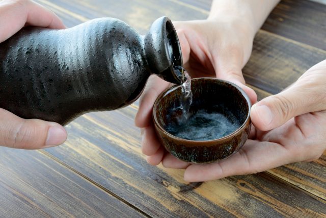 Sake being poured into a cup