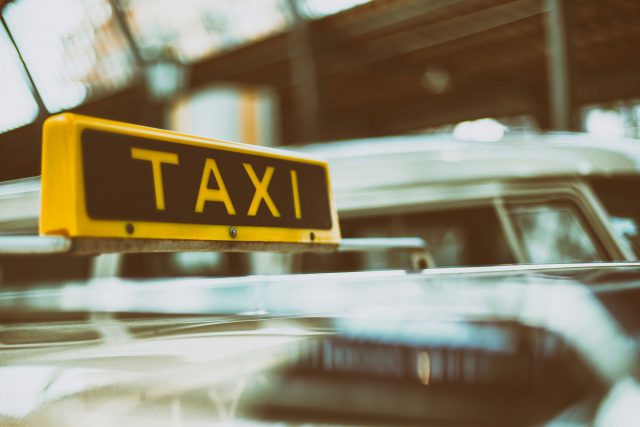 Taxi sign on top of car