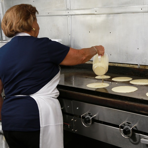 cook prepares pancakes for sugarbush maple syrup festival at bruces mill conservation park