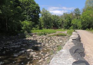 Armourstone wall, riffle, and gravel path along Wilket Creek Park.