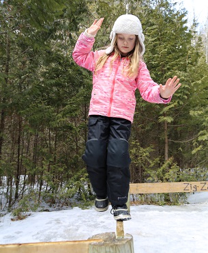girl practices wilderness survival activities during March Break camp at Claremont Nature Centre