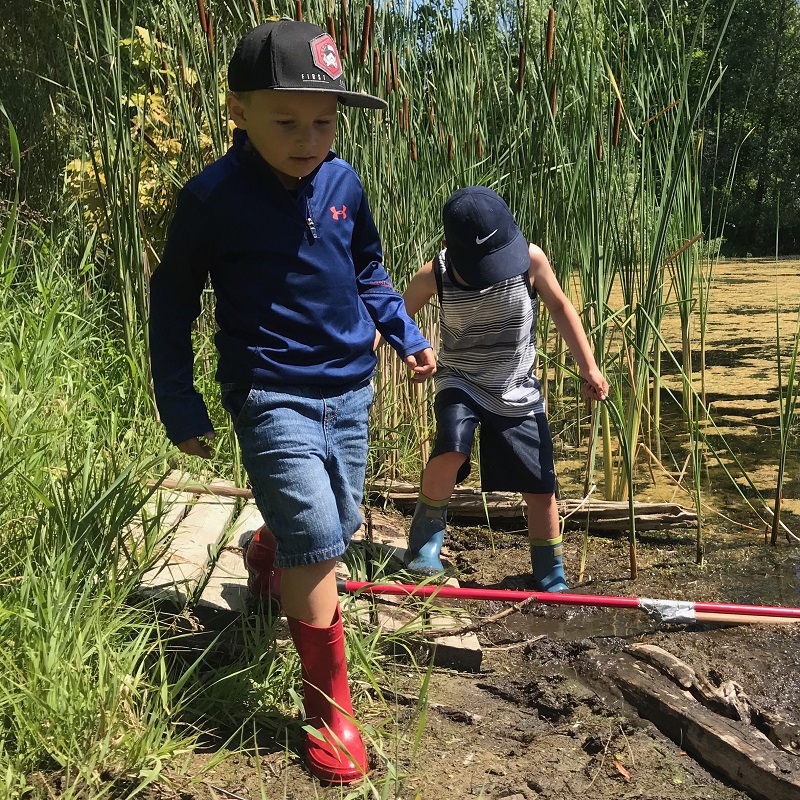 summer campers walk along edge of Lake St George