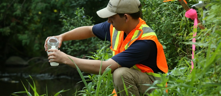 TRCA staff member conducts water sampling