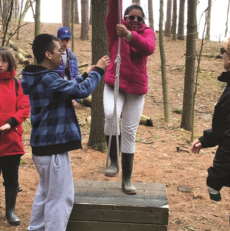 young woman tries low ropes at Albion Hills Field Centre Respite and Retreat Day
